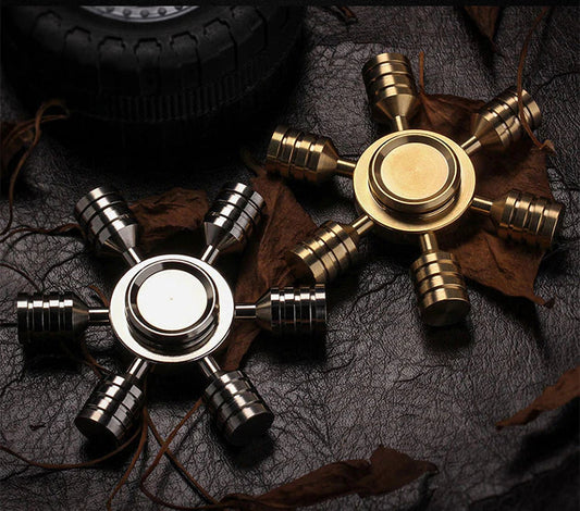 Golden and silver star-shaped copper fidget spinners, designed to enhance mindfulness and productivity, showcased as effective tools for focus and stress relief.