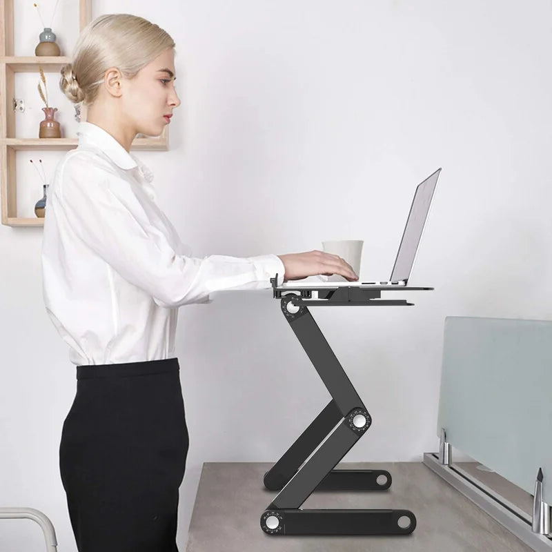 Woman using an ergonomic laptop stand with cooling fans, designed for improved posture and heat dissipation.