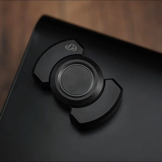 Close-up of the black carbon SpinZen™ fidget toy, featuring a sleek and modern design. Crafted from durable stainless steel, this unique variant offers tactile stress relief and ADHD management. Portable for convenient relaxation.